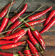 Red hot peppers over a table.