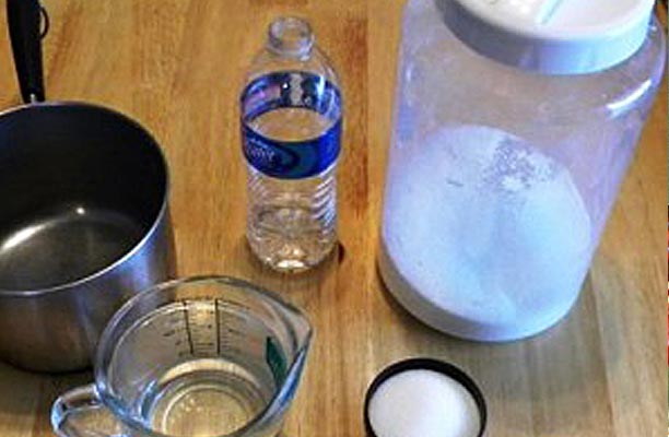 Cup of sugar, measuring cup of water and pot.